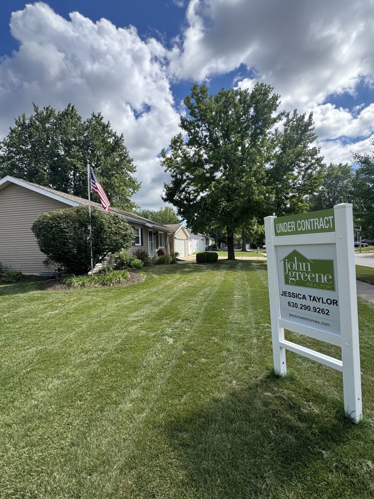 North Aurora home under contract with spacious yard and real estate sign by Jessica Taylor Realtor
